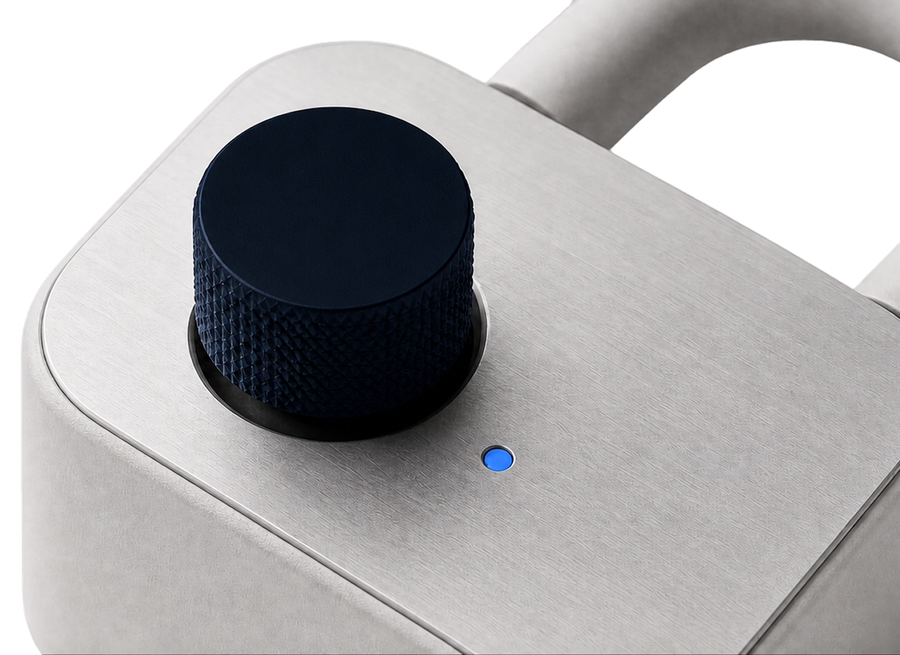 Close-up of a premium device with brushed metal surface, blue control dial, and indicator light.